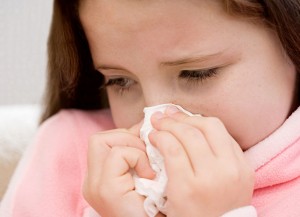 Girl blowing her nose